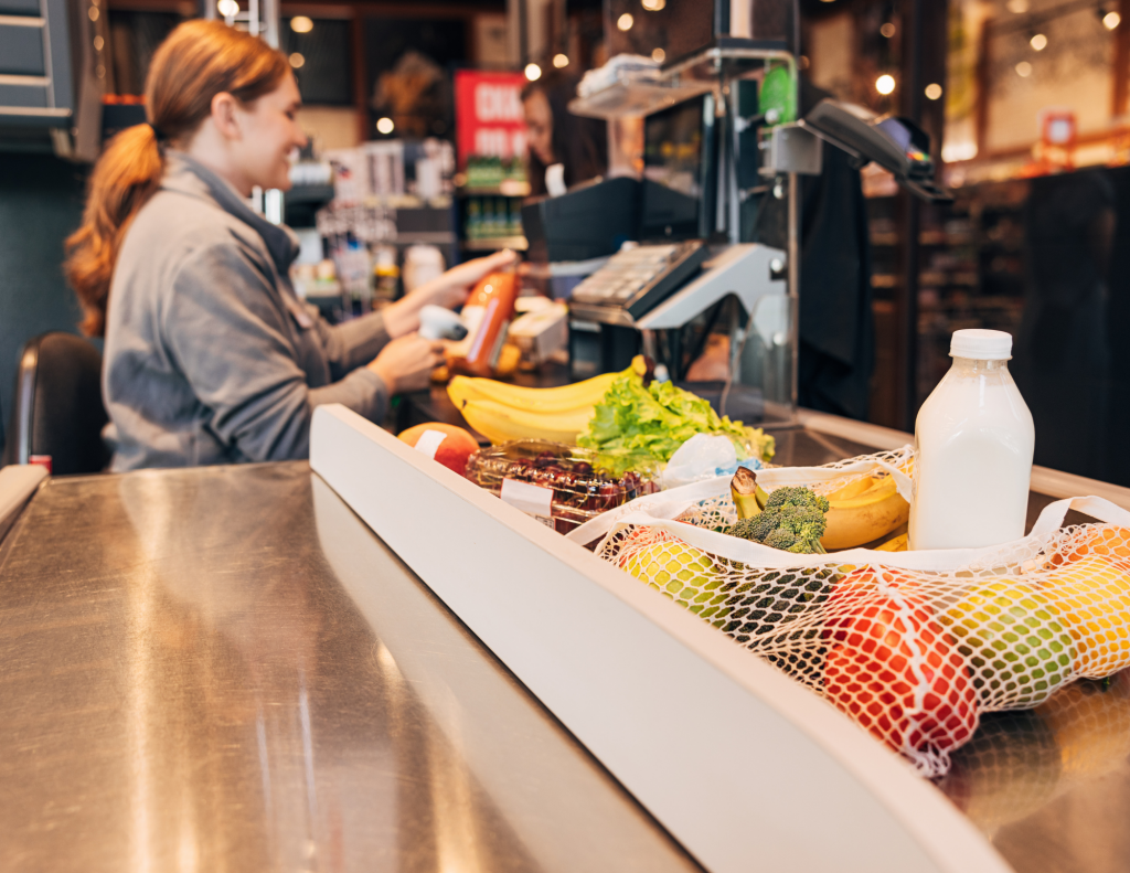A female cashier scanning groceries at a checkout counter. Walkbase’s real-time traffic data allows you to anticipate how many checkout lanes need to be open in the next 30 minutes based on current in-store footfall.