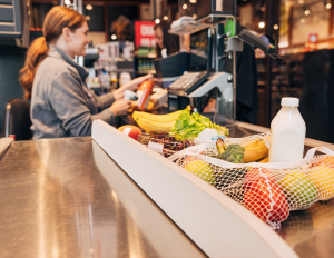 A female cashier scanning groceries at a checkout counter. Walkbase’s real-time traffic data allows you to anticipate how many checkout lanes need to be open in the next 30 minutes based on current in-store footfall.